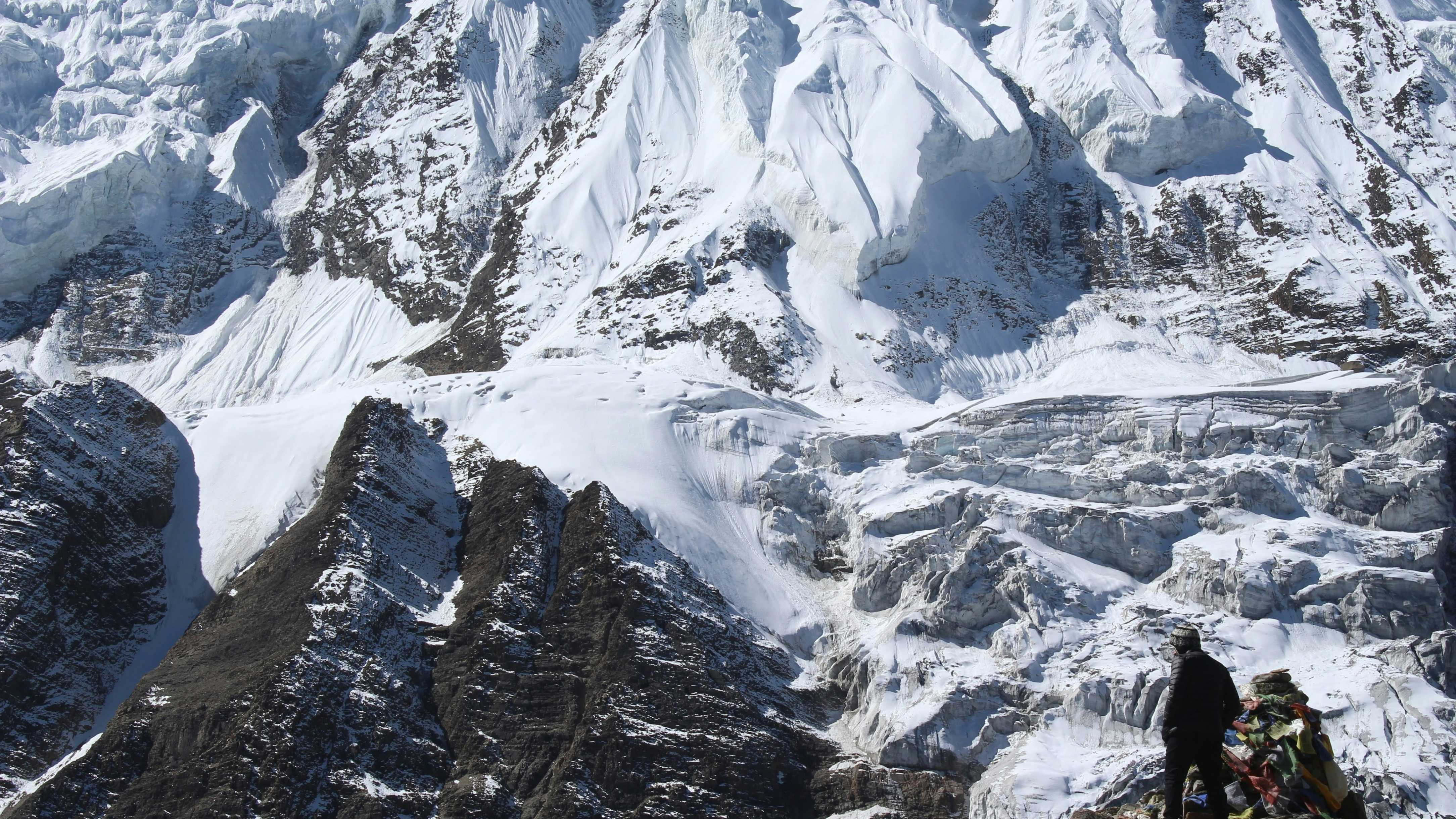 A hand holding a string of wooden prayer beads